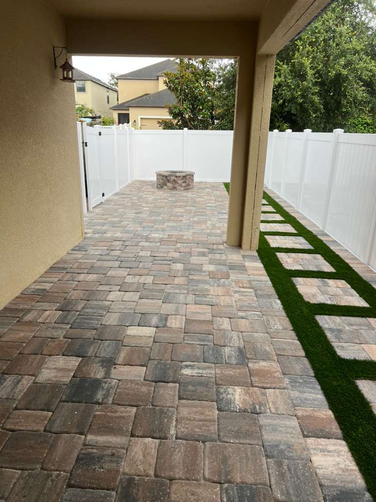 KS Solutions Covered Paver Patio with Fire Pit & Turf Stepping Stones install in Central Florida, FL